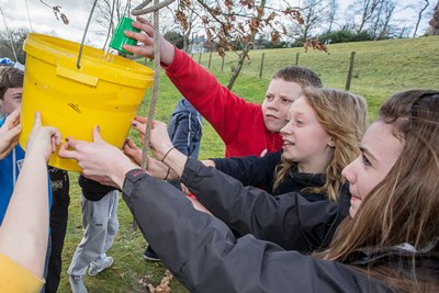 Youngsters from Gwynedd schools were at Glanllyn today and completed team building and initiative tests. Ceri Evans,14, right, Mirain Rhys, 13and Deio Williams, 13 all from Bala fill a bucket full of holes with water.