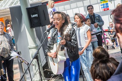 Love Wirral Festival at the Pyramids Shopping Centre, Birkenhead. Singer Tabitha Jade, with drummer Seth Beard and backing singer Eliza Mai