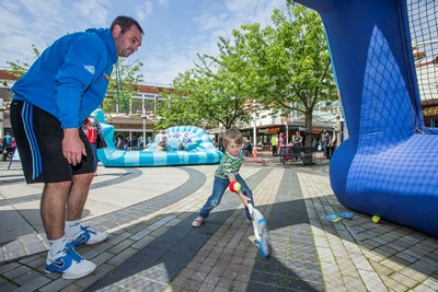 Love Wirral Festival at the Pyramids Shopping Centre, Birkenhead. trying his hand at tennis on an inflatable court is five years old Charlie Miles from New Brighton with Chris Thelwell, tennis development officer for Wirral.