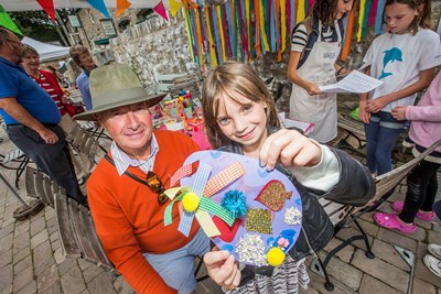 Bodnant Weksh Food Childrens Festival. Ten years old Grace Stephens with her masterpiece made in the Craft Corner with Grandfather Ray Valadini from Glan Conwy
