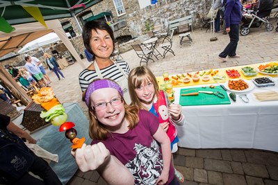Bodnant Weksh Food Childrens Festival. Pictured with their vegetable Kabob creations are Emily Bowen, 14 and her sister Ellie, 10 and Rhona Morris who teaches cookery in the Bodnant kitchen.