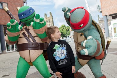 Teenage Mutant Ninja Turtles visit Eagles meadow Wrexham.Pictured are Turtles Leo and Raph with Dylan Hopson,7